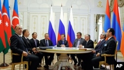 Russian President Dmitry Medvedev, center, Armenian President Serge Sarkisian, second right, and Azerbaijan's President Ilham Aliyev, second left, are seen during their meeting in the presidential palace of the Kremlin in Kazan, Russia, June 24, 2011.