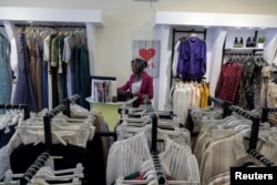 FILE - A woman works in a women's clothing store in Benghazi, Libya, June 19, 2021.