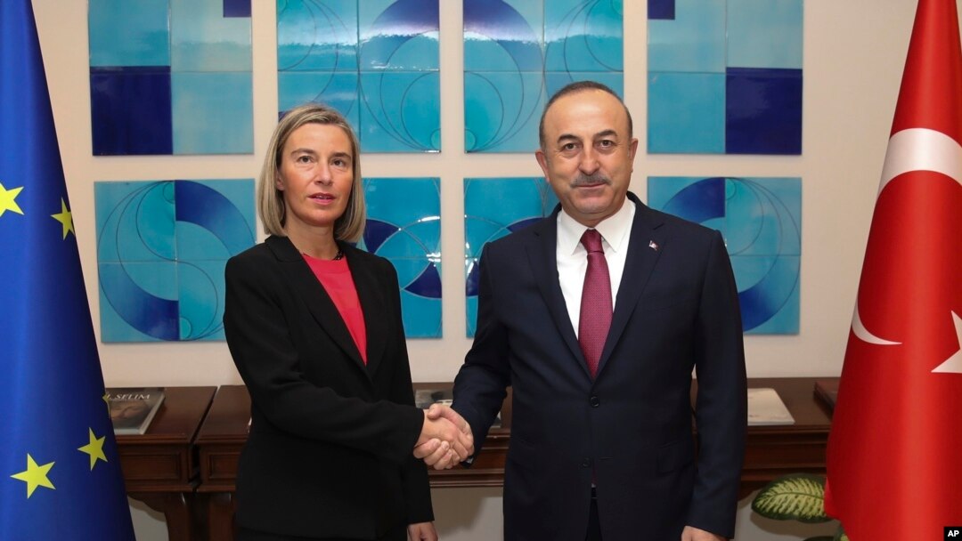 Turkish Foreign Minister Mevlut Cavusoglu, right, shakes hands with the European Union's foreign policy chief Federica Mogherini prior to their meeting, in Ankara, Turkey, Thursday, Nov. 22, 2018. 