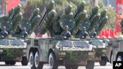 China's missiles are carried through Beijing's Tiananmen Gate during a military parade marking China's 60th anniversary in Beijing, China.