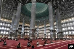 Muslim men pray at Istiqlal Mosque whose electricity partially come from solar power in Jakarta, Indonesia, March 29, 2023.