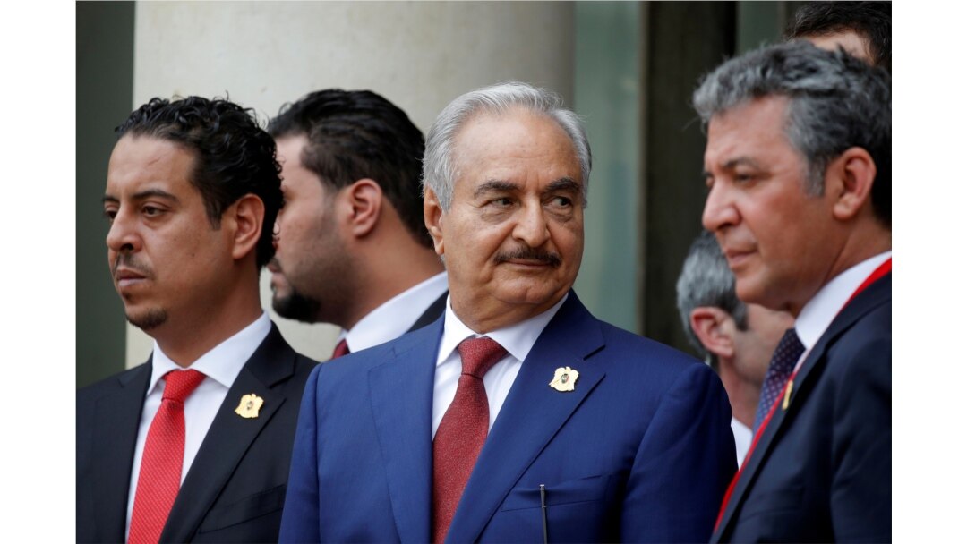 FILE - Khalifa Haftar, center, the military commander who dominates eastern Libya, leaves after an international conference on Libya at the Elysee Palace in Paris, May 29, 2018.