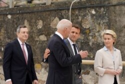 France's President Emmanuel Macron, U.S. President Joe Biden, European Commission President Ursula von der Leyen and Italy's Prime Minister Mario Draghi walk along the boardwalk during the G7 summit in Carbis Bay, Cornwall, Britain, June 11, 2021.