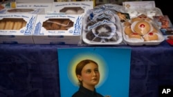 FILE - Handmade sweets made by the cloistered nuns of the Monjas Minimas monastery are displayed for sale at the door of a church in Jerez de la Frontera, southern Spain, on December 5, 2023.