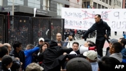 FILE —Private security try to break up skirmishes between anti-Chinese Communist Party protesters and pro-China protesters near the APEC summit in San Francisco, on November 16, 2023.