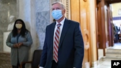 Sen. Lindsey Graham, R-S.C., leaves the chamber after taking an oath and voting on how to proceed on the impeachment against Trump, at the Capitol in Washington, Tuesday, Jan. 26, 2021. (AP Photo/J. Scott Applewhite)