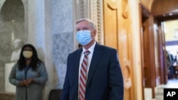 FILE - Sen. Lindsey Graham, R-S.C., leaves the chamber at the Capitol in Washington, Jan. 26, 2021.
