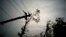 FILE - Power lines lay broken after the passage of Hurricane Maria in Dorado, Puerto Rico, Oct. 16, 2017.