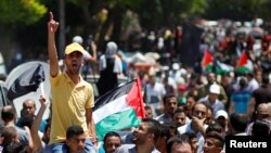 A Palestinian demonstrator gestures as he chants slogans during a protest against Bahrain's workshop for U.S. Middle East peace plan, in Gaza City, June 26, 2019.