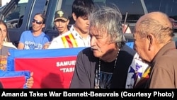 Oglala Lakota spiritual leader Steve DuBray and Richard Moves Camp offer prayers and words of encouragement for the three children returning home from Carlisle Industrial Indian School cemetery.