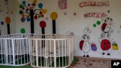 Empty cribs at a playhouse in the courtyard of Kherson regional children's home in Kherson, southern Ukraine, Friday, Nov. 25, 2022.