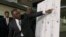 Pathologist, Dr. Bennet Omalu, gestures in front of a diagram showing the gun shot wounds he found on the body of police shooting victim Stephon Clark, during a news conference, March 30, 2018, in Sacramento, California.