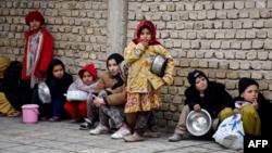 Afghan children queue to receive food aid distributed by a private charity foundation, in Mazar-i-Sharif on Feb. 16, 2025. 