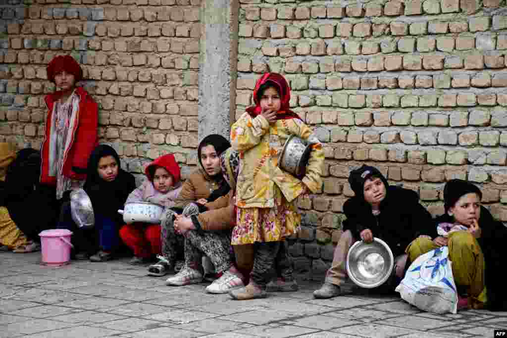 Afghan children queue to receive food aid distributed by a private charity foundation, in Mazar-i-Sharif, Feb. 16, 2025.