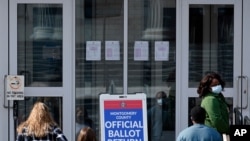 Residents line up outside the Montgomery County, Pa., Voter Services office, Oct. 19, 2020, in Norristown, Pa. 