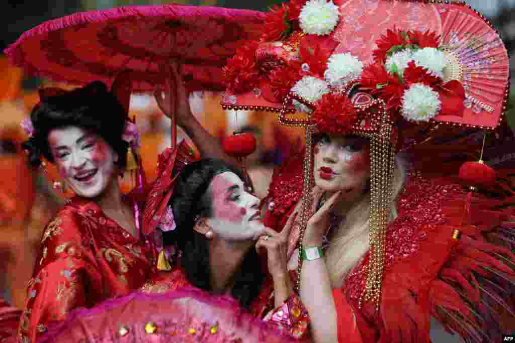 Performers in costume pose on the second day of the Notting Hill Carnival in west London.