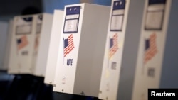 FILE - Voting booths are ready for the New York primary elections at a polling station in the Brooklyn borough of New York City, U.S., April 19, 2016. U.S. voters go to the polls November 8 to elect a new president and members of Congress.