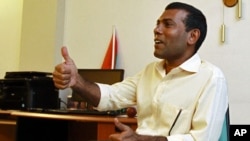 Former Maldivian president Mohamed Nasheed speaks with the media at his home in Male, February 9, 2012.