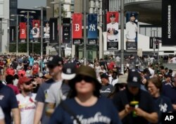 Fans arrive before a baseball game between the Boston Red Sox and the New York Yankees, June 29, 2019, in London. (AP)