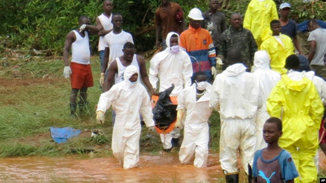 Rescue workers carry the body of a victim from the site of a mudslide in Regent, east of Freetown, Sierra Leone, Aug. 14, 2017. 