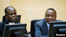 FILE - Kenya's President Uhuru Kenyatta, right, and a member of the Defense Council attend hearing at the International Criminal Court, The Hague, Netherlands, Sept. 21, 2011.