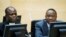 FILE - Kenya&#39;s President Uhuru Kenyatta, right, and a member of the Defense Council attend hearing at the International Criminal Court, The Hague, Netherlands, Sept. 21, 2011.