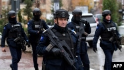 Kosovo Police officers patrol in the streets of Mitrovica, which is ethnically split between Serbs in the north and Albanians in the south, on November 30, 2024, as Kosovo stepped up security measures around critical infrastructure.