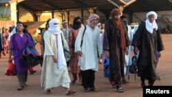 Para tahanan yang dibebaskan oleh pemerintah Mali sebum pembicaraan damai, berjalan di pangkalan udara militer Mali di Bamako, sebelum diterbangkan ke bagian utara negara tersebut (15/7).