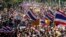 Thai anti-government protesters march in a street, in Bangkok, Thailand, Dec. 22, 2013.