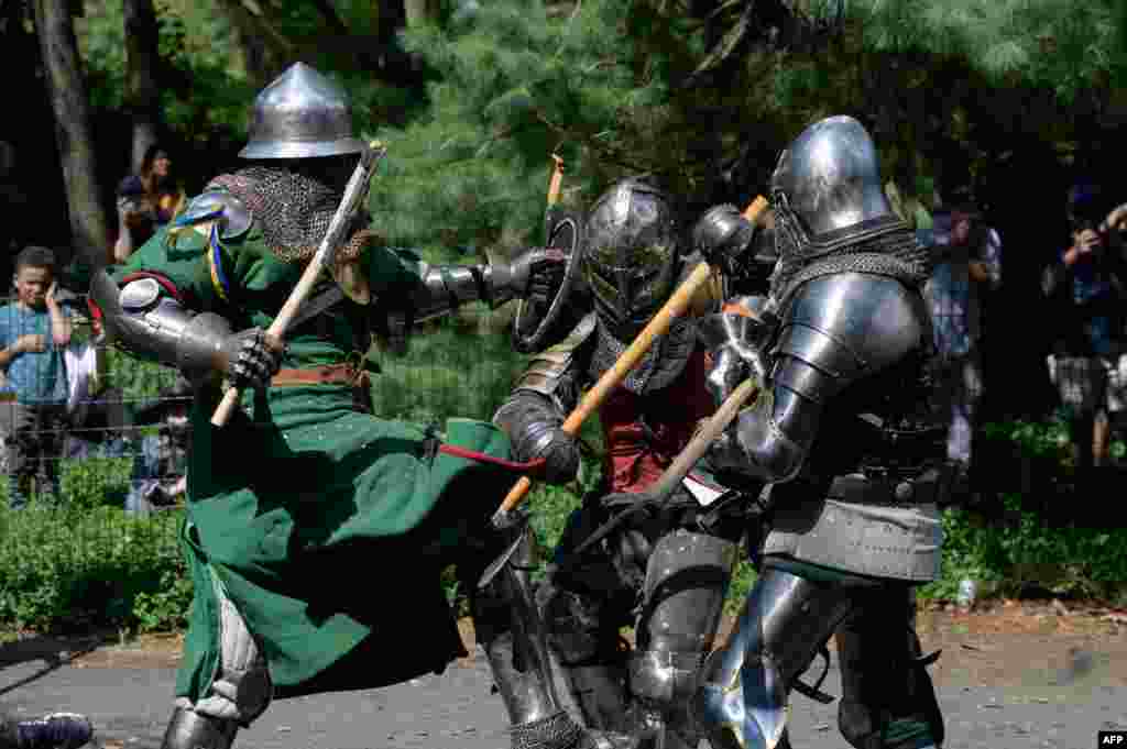 Members of the &#39;Gladiators NYC&#39; armored combat group fight in Central Park, New York, July 10, 2021.