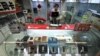 FILE - In this Feb. 17, 2011 file photo, a vendor works at a store selling Huawei network devices at a computer mall in Beijing, China. Huawei Technologies Ltd., a major Chinese telecoms equipment maker, is scrapping its effort to acquire a U.S. computer