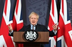 British Prime Minister Boris Johnson holds a news conference in Downing Street in London, Dec. 24, 2020.