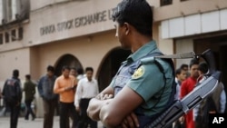 A Bangladeshi riot policeman stands guard in front of the Dhaka Stock Exchange during a demonstration in Dhaka, Bangladesh, January 24, 2012.