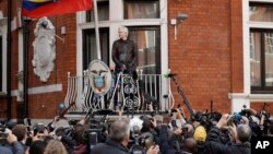 WikiLeaks founder Julian Assange stands on the balcony of the Ecuadorian embassy prior to speaking, in London, May 19, 2017.