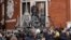 FILE - WikiLeaks founder Julian Assange stands on the balcony of the Ecuadorian embassy, prior to speaking, in London, May 19, 2017.