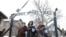 FILE - Holocaust survivors walk outside the gate of the Auschwitz Nazi death camp in Oswiecim, Poland, Jan. 27, 2015. 