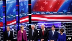 FILE - From left, Democratic presidential candidates Michael Bloomberg, Elizabeth Warren, Bernie Sanders, Joe Biden, Pete Buttigieg, Amy Klobuchar, stand on stage before a primary debate in Las Vegas, Nevada, Feb. 19, 2020.