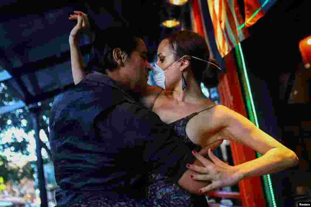 Makrina Anastasiadou and her tango partner &quot;El Morocho&quot; dance in public at a mostly empty restaurant after the suspension of public gatherings for at least 15 days to prevent the spread of coronavirus, in Buenos Aires, Argentina, March 16, 2020.