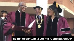 Robert F. Smith, left, laughs with David Thomas, center, and actress Angela Bassett at Morehouse College on Sunday, May 19, 2019, in Atlanta, Georgia. (Bo Emerson/Atlanta Journal Constitution via AP)