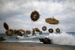 LE - Amphibious assault vehicles of the South Korean Marine Corps fire smoke bombs as they move to land on the shore as part of the U.S.-South Korea annual joint military training called Foal Eagle, in Pohang, South Korea, April 2, 2017.