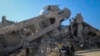 A family rides in a horse-drawn cart past a destroyed mosque in Beit Lahia, northern Gaza Strip, Jan. 29, 2025.