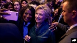 FILE - Democratic presidential candidate Hillary Clinton takes a photograph with a member of the audience after speaking at a Women for Hillary fundraiser at the Hyatt Regency in Washington.