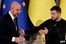 Ukrainian President Volodymyr Zelenskyy gestures toward European Council President Charles Michel after a press conference following their talks in Kyiv on Nov. 23, 2023.