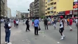 Police vehicle mowing down protesting Mozambican woman