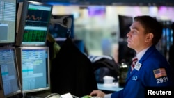 A trader works on the floor of the New York Stock Exchange shortly after the market opening, Dec. 16, 2013. 