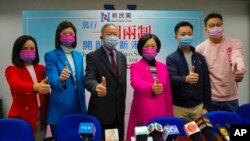 Members of New People's Party, from left, Judy Chan, Eunice Yung, Lai Tung-kwok, Regina Ip, Dominic Lee and Marcus Liu pose for a photograph after winning the legislative election in Hong Kong, Dec. 20, 2021.