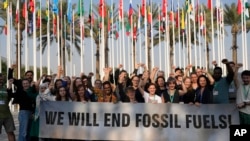 សមាជិក​នៃ​ Greenpeace ថតរូប​នៅកិច្ច​ប្រជុំ​កំពូល​​ COP28 U.N. កាលពីថ្ងៃទី ១៣ ធ្នូ ឆ្នាំ២០២៣ទីក្រុង Dubai។ (AP Photo/Rafiq Maqbool)
