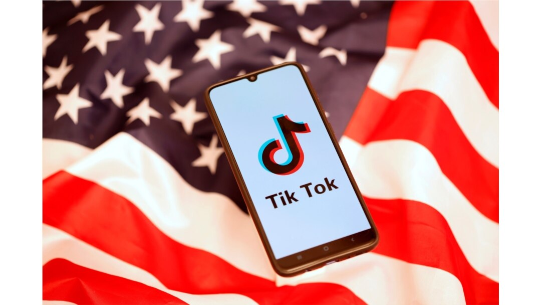 Tik Tok logo is displayed on the smartphone while standing on the U.S. flag in this illustration picture taken, Nov. 8, 2019.