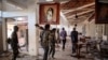 Amhara Fano militia fighters walk in the ransacked terminal at the Lalibela airport in Lalibela, Ethiopia, Dec. 7, 2021.