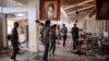 FILE - Amhara Fano militia fighters walk through a ransacked building at the airport in Lalibela, Ethiopia, Dec. 7, 2021. In August 2023, months of fighting between the federal government and Fano forces reached its peak, leading to a shortage of goods in the Amhara region.